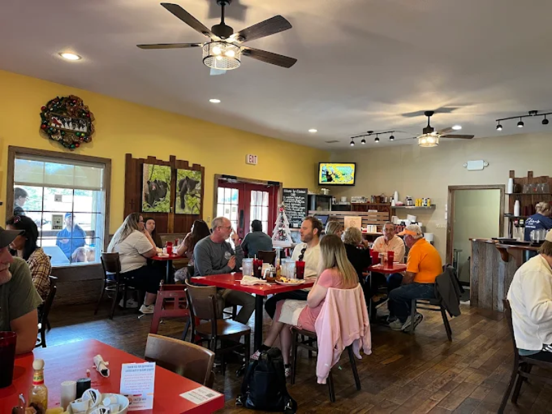 Busy dining scene with guests enjoying food at Elvira’s Café
