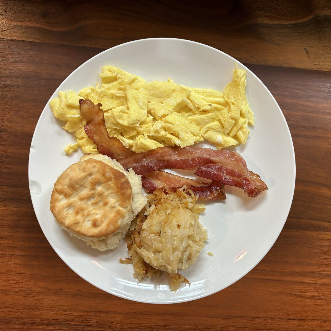 Early riser with hash brown casserole, scrambled eggs, bacon, and a biscuit